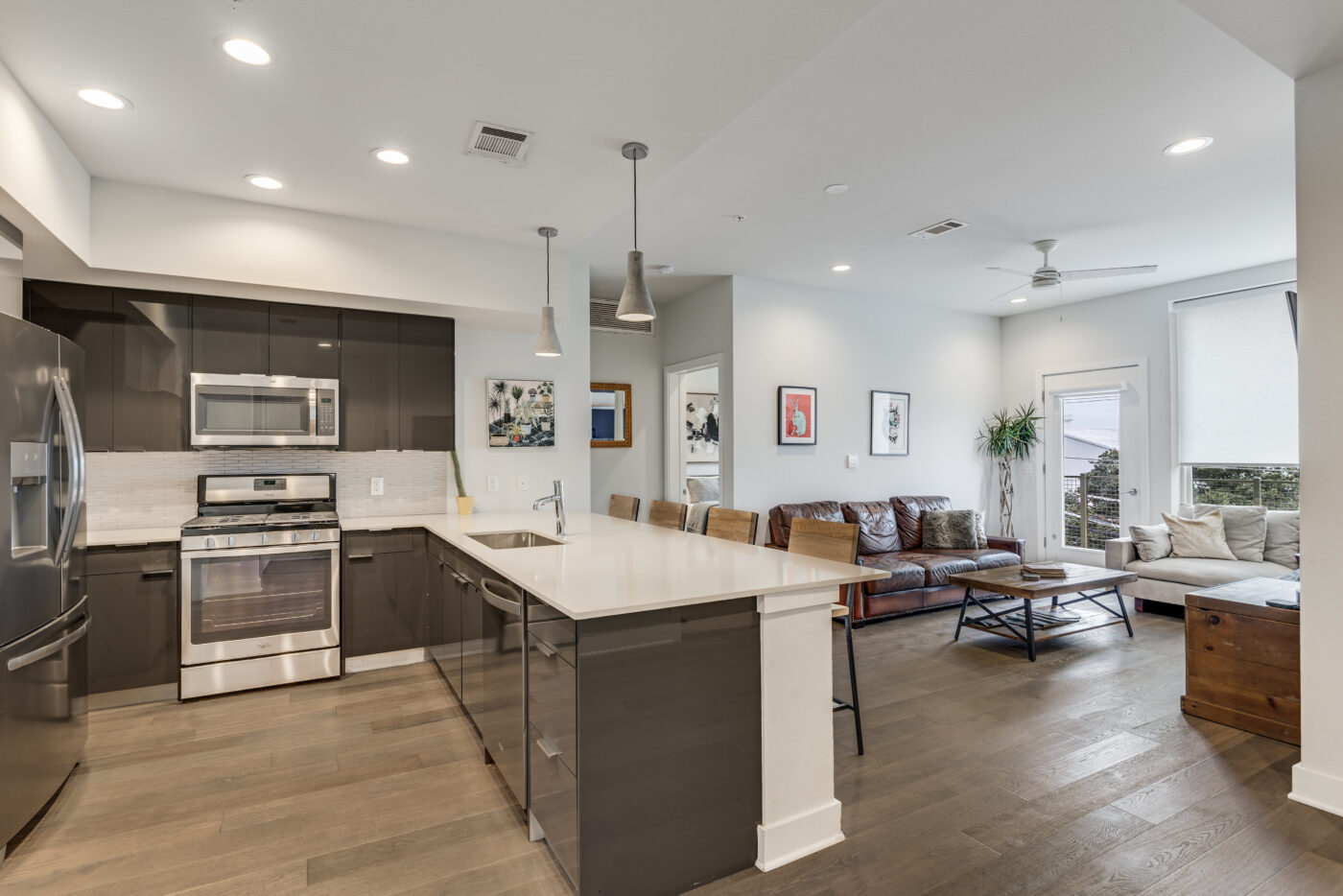 Spacious living room with modern finishes and abundant natural light from the East-facing balcony.